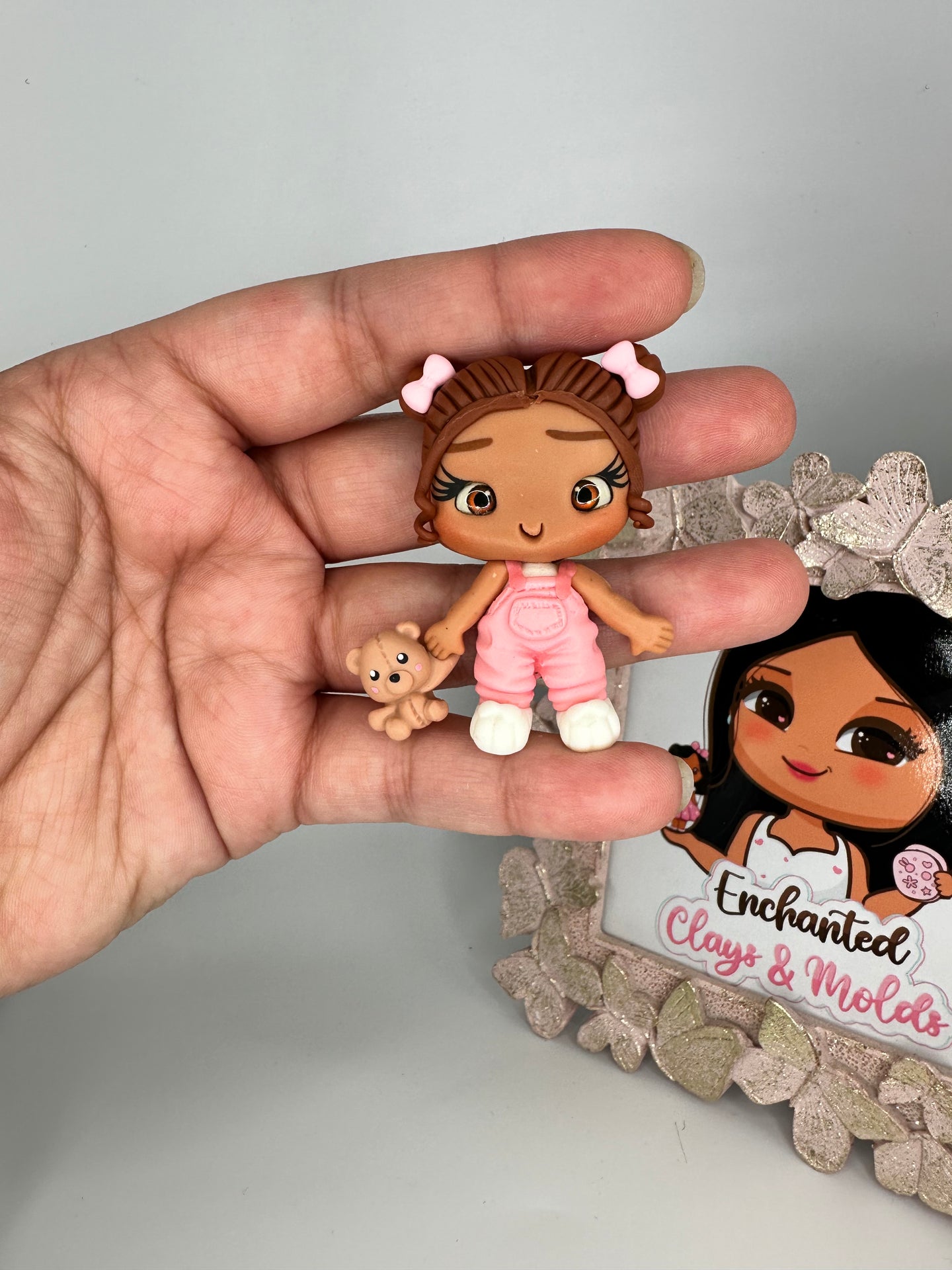 Girls in pink overall's clay dolls